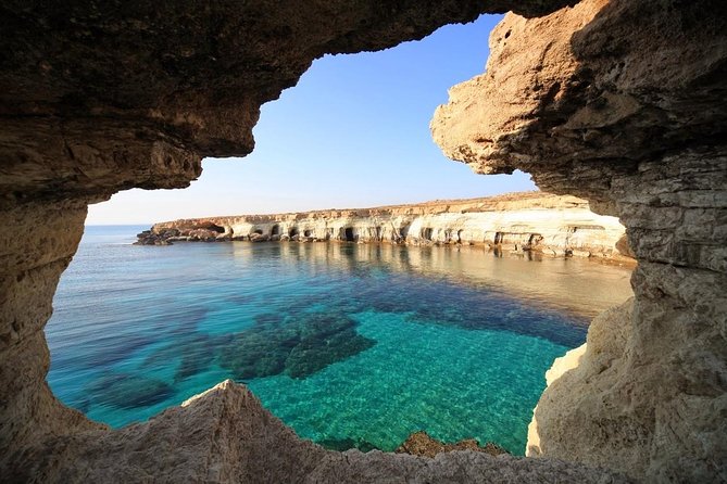 Limestone sea arch and clear water on the Cape Greco coast